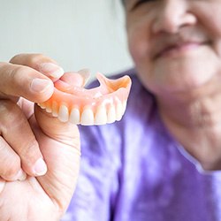 Remove your dentures to clean them after each meal