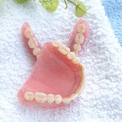 keep your dentures safe when cleaning them by placing a towel underneath them