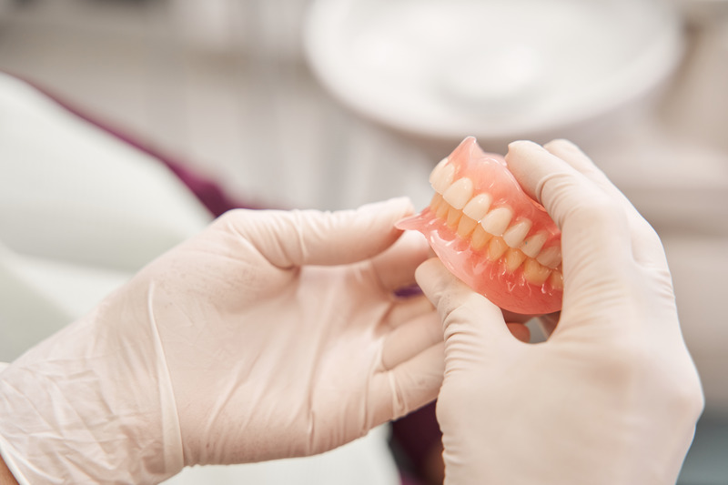 Dentist handling new dentures